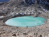 55 Emerald Gaurikund Lake Just After the Dolma La On Mount Kailash Outer Kora Just after the Dolma La, the trail descends steeply to the emerald lake called Gaurikund by the Hindus. Hindus are supposed to take a ritual bath here, a baptism into their new life. The Tibetans call it Tukji Chenpo Tso, the lake of compassion.